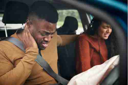 driver and passenger with whiplash, concept of Atlanta car accident lawyer
