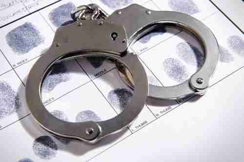 Handcuffs and fingerprints, concept of Atlanta criminal defense attorney