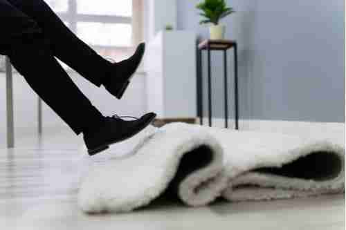 Man slipping and falling on rug, concept of premises liability lawyer in Decatur