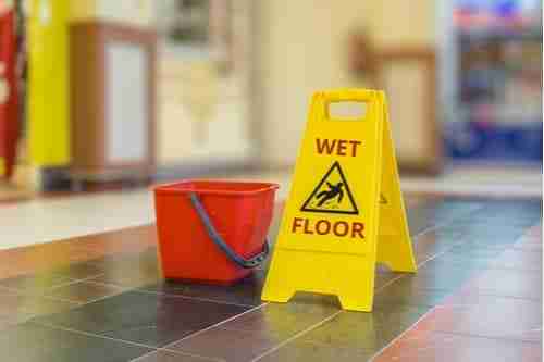 Wet floor sign, concept of Druid Hills premises liability lawyer