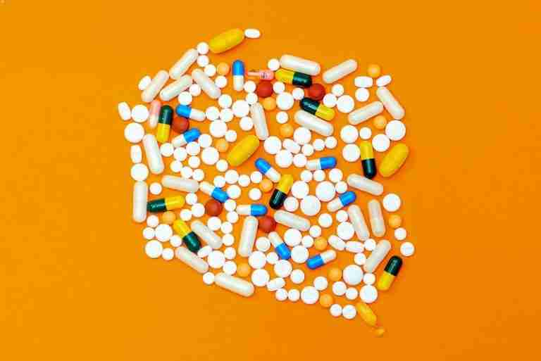 Image is of a mix of prescription drugs against an orange background, concept of Decatur prescription drug dui defense lawyer