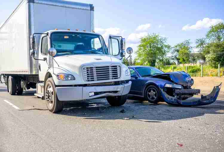Image is of a semi-truck and car accident.