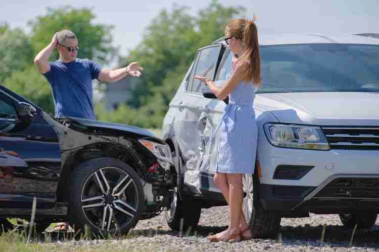 man and woman discuss car accident damages